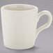 A white Tuxton espresso cup with a handle.