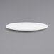 A close-up of a white Front of the House Canvas round porcelain plate with a small rim on a gray surface.