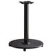 A black Lancaster Table & Seating cast iron table base on a table.