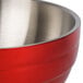A red Vollrath beehive serving bowl with a stainless steel handle.
