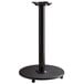 A black metal Lancaster Table & Seating counter height table base with FLAT Tech Equalizer table levelers.