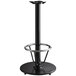 A Lancaster Table & Seating black cast iron bar height table base with a foot rest and self-leveling feet.