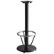 A Lancaster Table & Seating black cast iron bar height table base with a round foot rest and self-leveling feet.