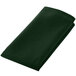 A folded green cloth on a white background.