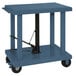 A blue metal lift table cart with swivel casters.