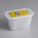 A white plastic container of Matfer Bourgeat ceramic pie weights with a yellow label.