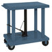 A blue metal Wesco lift table with swivel casters.