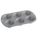 A silver Wilton muffin pan with six holes.