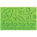 A green silicone Wilton mold with flowers, leaves, a bird, and a worm.