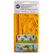 A packaged Wilton plastic mold with jungle animals.