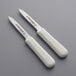 Two white Dexter-Russell Sani-Safe paring knives with smooth blades.