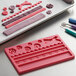 A Wilton silicone mold tray with a variety of ribbon and fabric shapes.