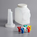 A white Vollrath plastic pour container with a white lid and a set of colorful spouts.