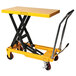 A yellow Wesco heavy-duty scissors lift table with black legs.