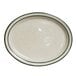 A white Tuxton china platter with a green speckled rim.