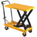 A yellow and black Wesco scissor lift table with wheels.