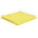 A yellow Intedge vinyl table cover with flannel back folded up on a white background.