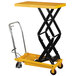 A yellow and black Wesco scissor lift table.