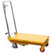 A Wesco yellow scissor lift table with wheels.