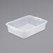 A white plastic Vollrath Traex food storage box with a lid on a gray surface.