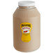 A Pilsudski gallon jar of mustard with a yellow label on a white background.