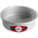 A round silver cake pan with a red and white label.