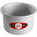 A silver cake pan with a red and white label.