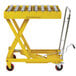 A yellow Wesco roller top scissors lift table with metal rods.