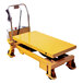 A yellow Wesco Industrial Products electric scissor lift table.
