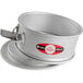 A round silver Fat Daddio's anodized aluminum springform cake pan with a clip on the bottom.