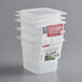 A stack of Cambro translucent plastic food pans with seal covers.