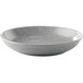 A gray Moon Coupe bowl with a white rim on a white speckled plate.