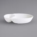 A white bowl with two small bowls on top.