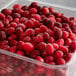 A plastic container of 40 lb. IQF Whole Cranberries.