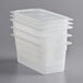 A stack of Cambro translucent polypropylene food containers with seal covers.