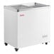 A white Galaxy flat top display freezer with a glass top on wheels.