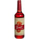 A Torani Puremade Blood Orange Flavoring Syrup 750 mL glass bottle of red liquid with a label.