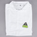 A folded white Cordova Disposable Microporous Lab Coat with a yellow and green logo on it.