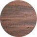 A Lancaster Table & Seating Excalibur round wood table top with a textured walnut finish.