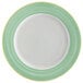A white porcelain plate with a rolled edge and green and yellow rim.