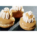 Sasa Demarle Flexipan Air Silicone choux mold with 28 pastries topped with cream and caramel.