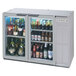 A Beverage-Air underbar wine refrigerator with glass doors filled with bottles of beer.