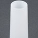 A white cylindrical sausage stuffer tube on a gray surface.