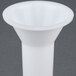 A white plastic funnel for a Backyard Pro sausage stuffer tube on a gray background.
