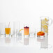 A Schott Zwiesel Paris juice glass filled with liquid with an orange peel.