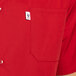 A man wearing a red Uncommon Chef cook shirt with a pocket.