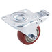 A metal plate caster with a red wheel and brake.