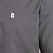 The back of a slate gray Uncommon Chef cook shirt with a pocket.