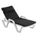 A black chaise cushion with pillow on a white chaise lounge chair.