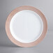 A white plastic plate with a rose gold lattice design.